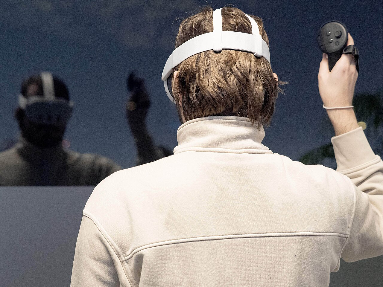 Player wearing a VR headset and controller